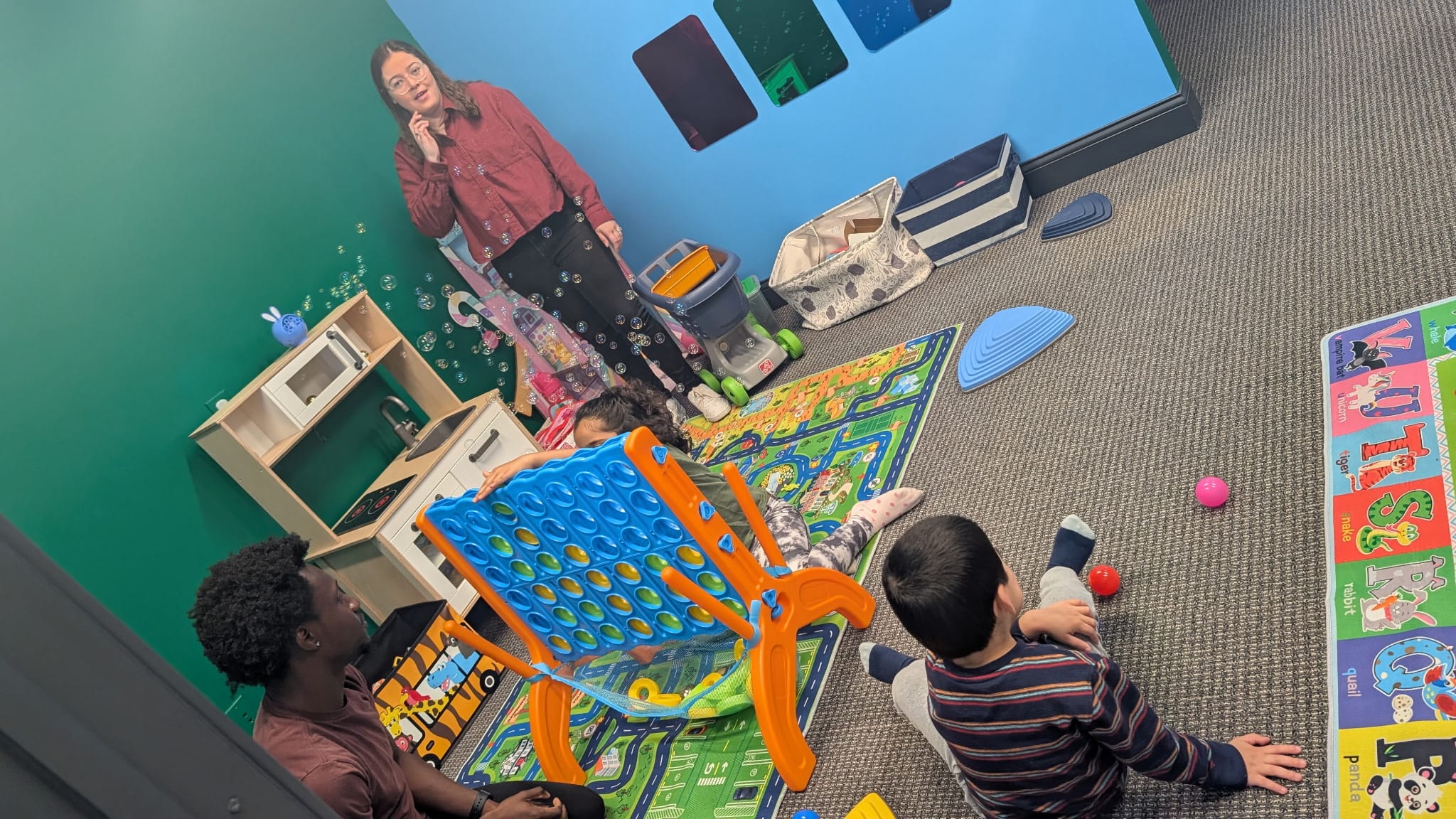 Staff and kids playing Connect 4